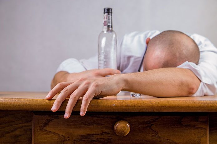 Pijany mężczyzna leżący na stole